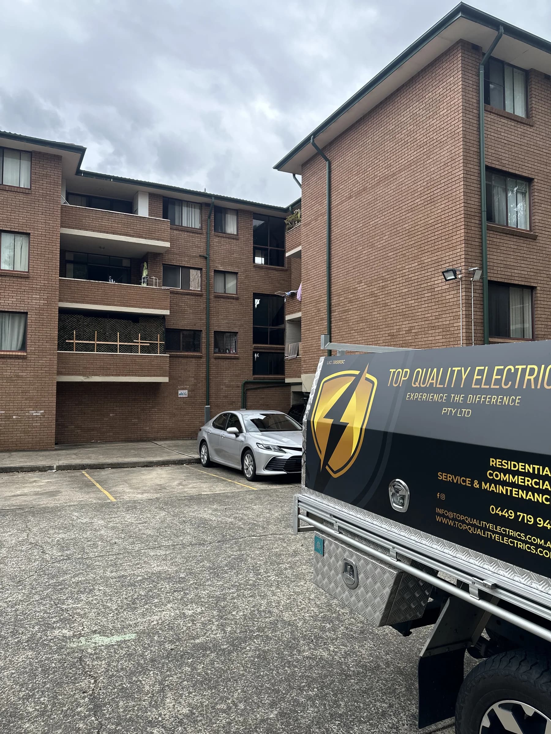 Top Quality Electrics branded service vehicle at a customer property